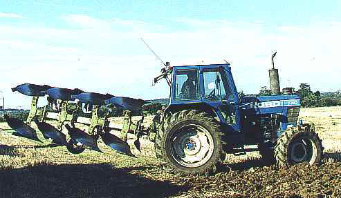 Tractor and four-furrow plough